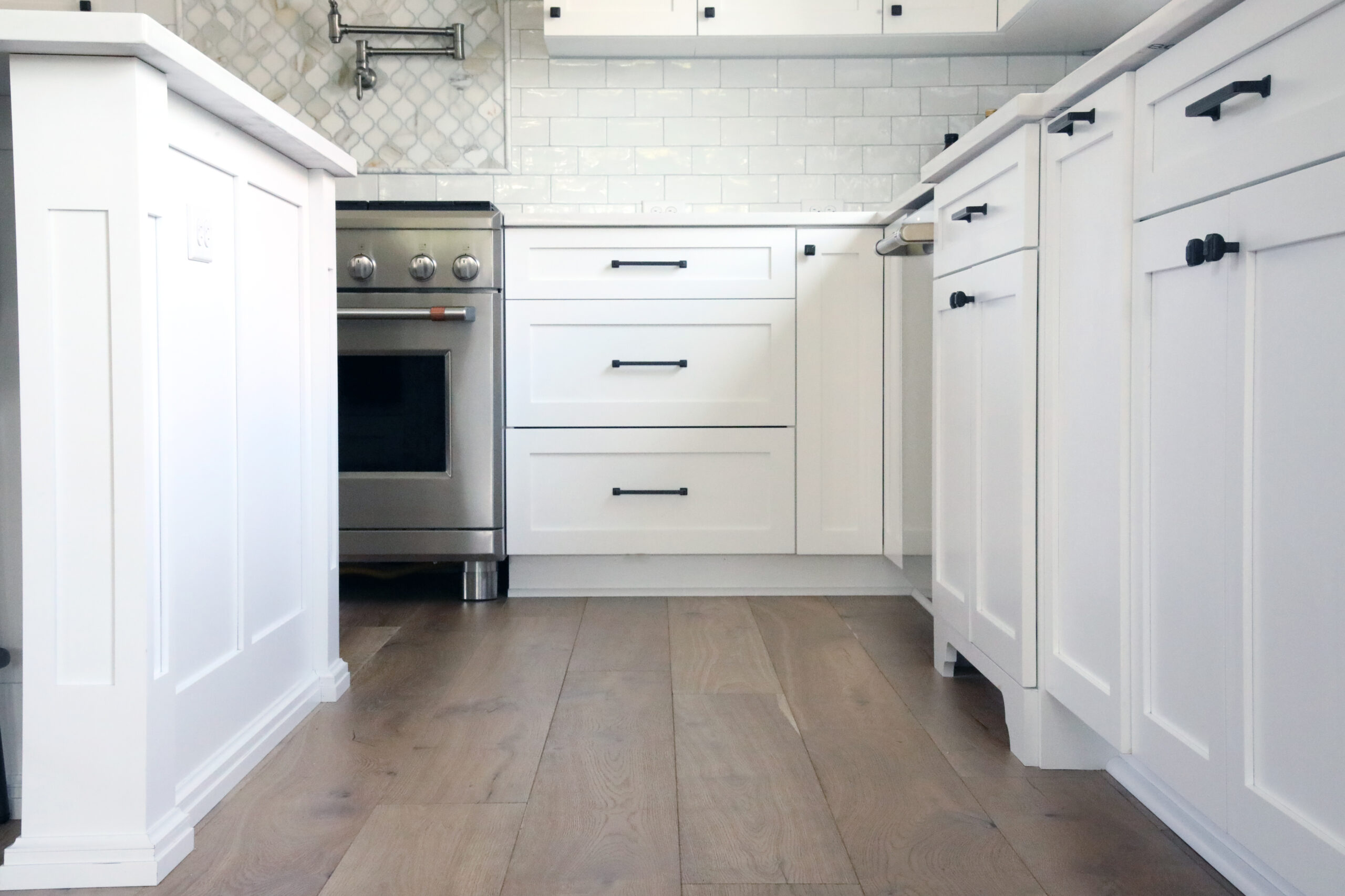 Farmhouse Kitchen with white cabinets and black hardware